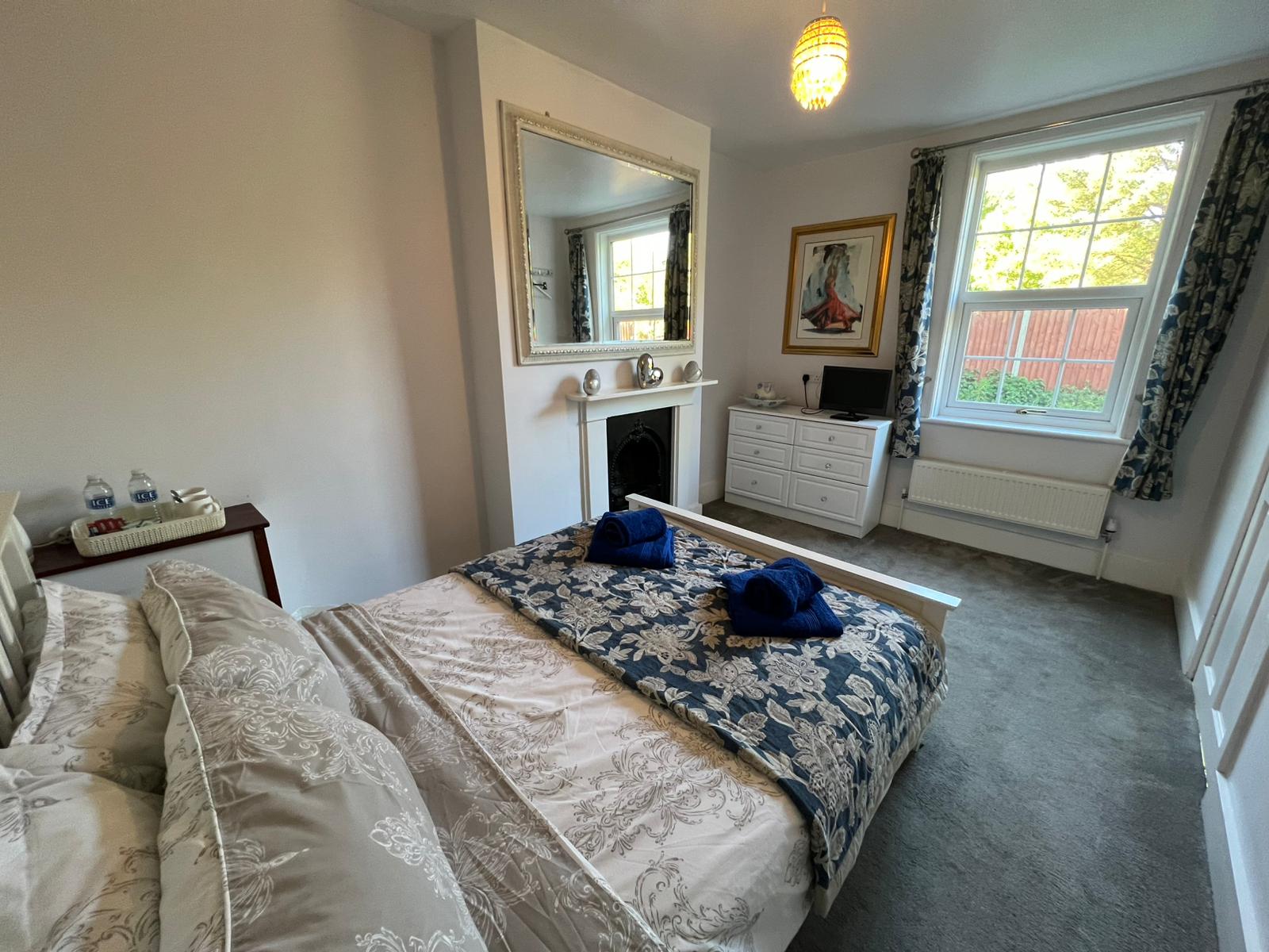 Double Room 5 at The Old Alma — double bed with period fireplace and bright windows